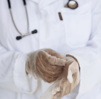 nurse putting on gloves