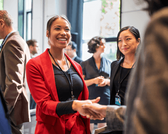University Impact Alumni | Business woman handshaking | THINK Education