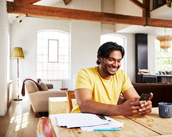 Studying with us | Think Education | Man smiles looking at phone