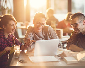 Studying with us | Think Education | Three students looking at laptop