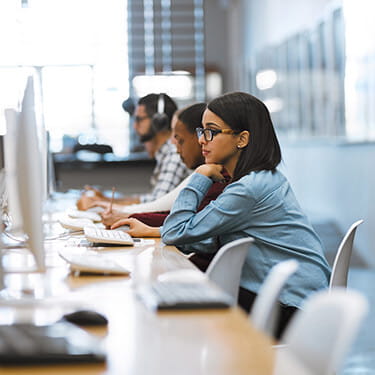 How to apply to Think Education | Student on computer in library
