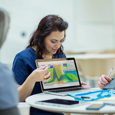Scholarships | Health | Woman Presenting Laptop | Large