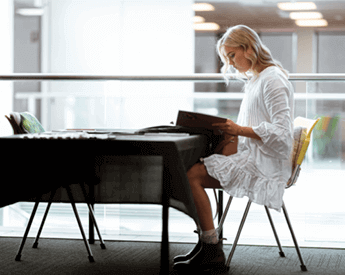 Torrens University Australia Events | Woman student sitting at a desk reading
